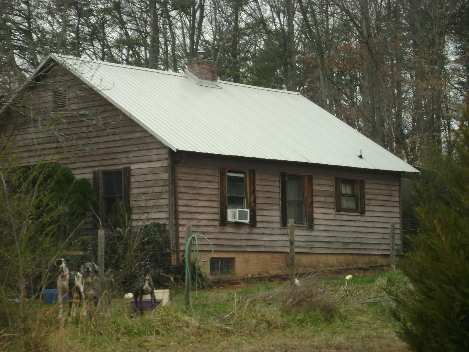 White metal roof on an old wood sided farmhouse, from a Metal Roof Installation job in Commercial Point